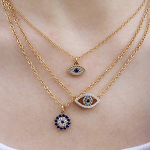 Three-layer gold stainless steel necklace with blue evil eye pendants worn on neck