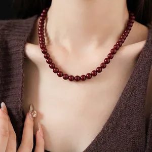 Vintage style Ancora red beaded titanium steel necklace shown on a model for a chic look