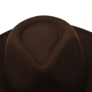 Close-up of a dark brown wool felt cowboy hat showing texture and creased crown detail