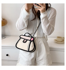 Detail of cartoon style 2D beige and pink crossbody bag with bold black outlines and chain