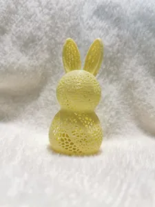 Close-up of 3D printed yellow rabbit lamp featuring a modern hollow mesh structure