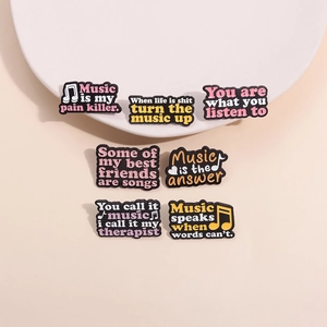 Set of 7 music-themed enamel pins featuring motivational quotes and musical notes on black metal