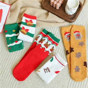 Cozy Christmas coral fleece socks with reindeer and gingerbread patterns in a home setting