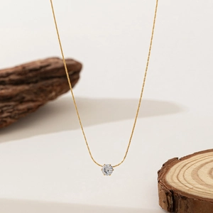 Minimalist gold necklace featuring a classic six-prong sparkling zircon pendant on a thin chain