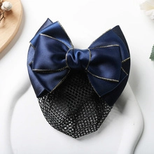 Detailed view of blue satin ribbon hair clip with black snood net and gold trim edges