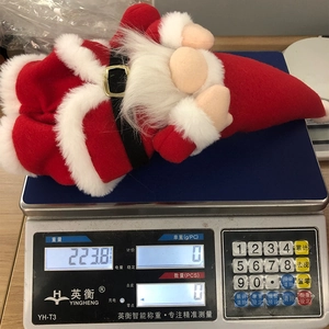 Detailed view of long-legged Santa gnome weighing approximately 223.8g on a digital scale