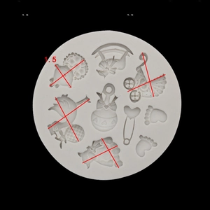 Macro shot of grey silicone mold showing detailed baby bottle and stroller patterns