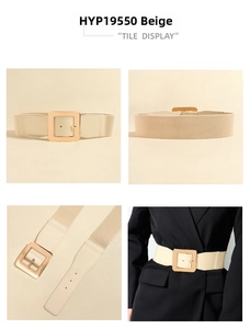Detail of beige elastic waist belt featuring a large polished square gold metal buckle