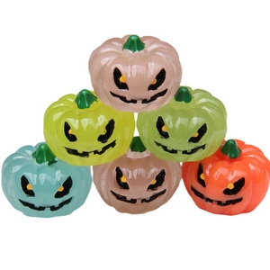 Set of 6 glowing 3D Halloween miniature pumpkins with carved faces on white background