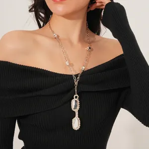 Silver-toned Y-shaped long necklace with cubic zirconia pendants worn by model