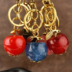 Exquisite apple keychains in red and blue glitter finish with gold metal rings