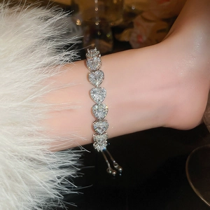 Detailed close-up of heart-shaped pink rhinestone bracelet with adjustable slider clasp