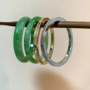 Minimalist resin jade-style and metallic bangle set with green, gold and silver finishes