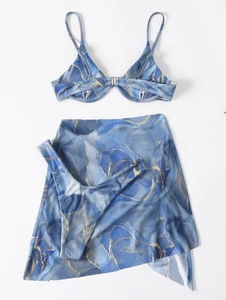 Detailed view of three-piece marble print bikini set including matching sarong wrap