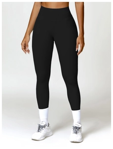 Detail of high waisted black leggings paired with white socks and retro sneakers