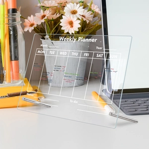 Weekly Planner acrylic board with metal stands on desk showing tasks like vacuum and notes