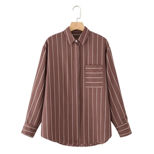 Detail of a brown striped shirt featuring a classic collar and a contrast pocket design