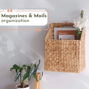 Handwoven rattan wall basket for magazines and mail organization in a minimalist room
