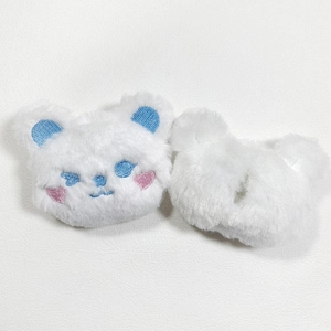 Detailed view showing the soft plush texture and heart blush embroidery on white bear brooch