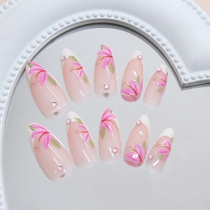 French lily press-on nails with pink glitter and rhinestones in long almond shape