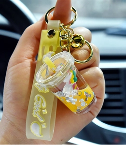 Macro detail of unicorn liquid sand keychain with yellow boba cup and silicone strap
