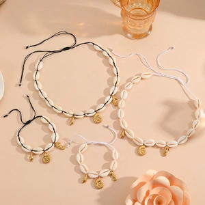 Flat lay of seashell jewelry set featuring starfish pendants and woven cotton cords