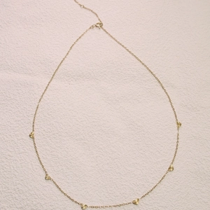 Titanium steel gold necklace with six radiant heart pendants arranged in a circular layout