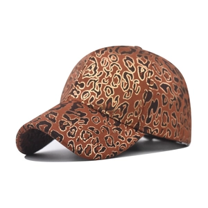 Detailed close-up of dark brown baseball cap with golden leopard print on faux suede