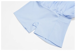 Macro detail of sky blue tennis skort showing built-in shorts with a side phone pocket