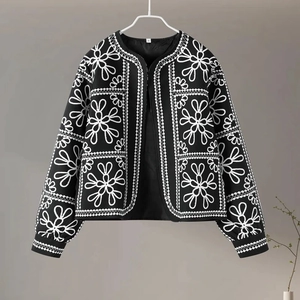 Detail view of the black and white floral print jacket with visible S size neck label