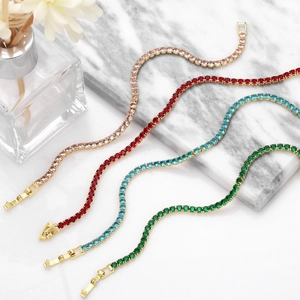 Close-up of four-claw tennis bracelets with multi-colored cubic zirconia on marble