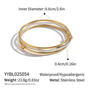 Detail view of two-tone gold and silver stackable bangles showing size and weight