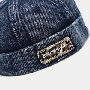 Vintage dark blue washed denim docker cap with retro embroidery and rolled brim for men