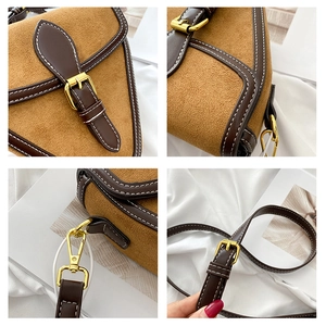 Detalle del bolso de cuero marrón esmerilado con herrajes dorados y correa de hombro