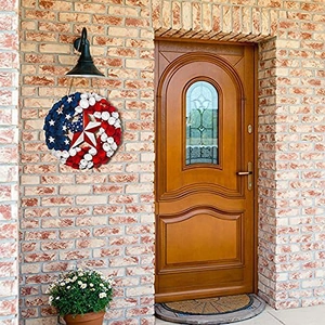 Detail of Fourth of July American flag wreath hanging on a rustic brick wall