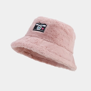 Detail of pink faux fur bucket hat featuring a colorful camera embroidery patch