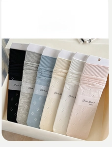 Set of six pastel mesh socks in a white gift box with detailed pointelle knitting
