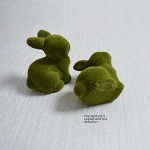 Detail view of moss green flocked rabbit base showing the sealed bottom closure feature