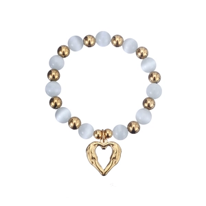 Detailed view of beaded bracelet featuring glossy cat eye stones and heart pendant