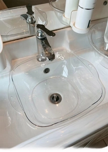 Macro view of transparent square washbasin fitting perfectly into a bathroom sink
