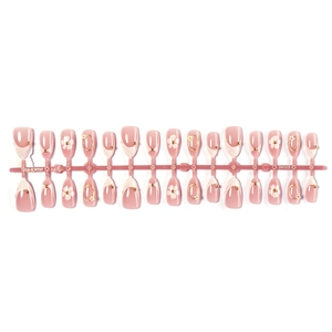 Short almond press-on nails with white flower designs and gold accents on pink base