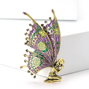 Elegant butterfly fairy brooch with purple enamel and gold finish on white background