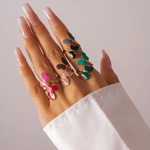 Detail shot of stackable butterfly rings with colorful enamel drip on gold plating
