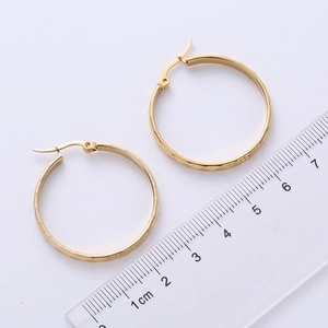 Classic golden hoop earrings with textured finish and size reference measurement
