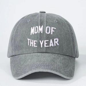 Macro detail of the white Mom of the Year embroidery on a grey washed denim baseball cap
