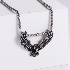 Detailed view of vintage eagle pendant with spread wings on silver box chain