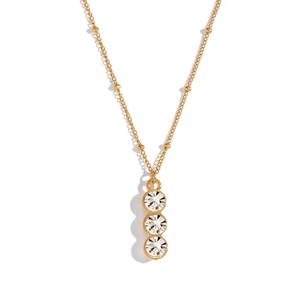 Macro shot of gold bead chain necklace with three vertical round zircon stones