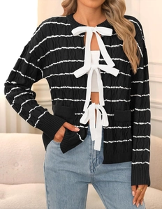 Close-up of black and white striped knit cardigan with delicate bow tie closures