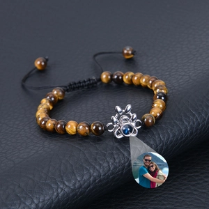 Detailed view of tiger eye stone bracelet with custom photo projection charm