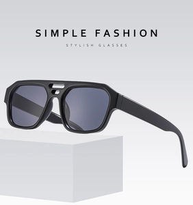 Detail view of black square frame sunglasses with double bridge on geometric display stand